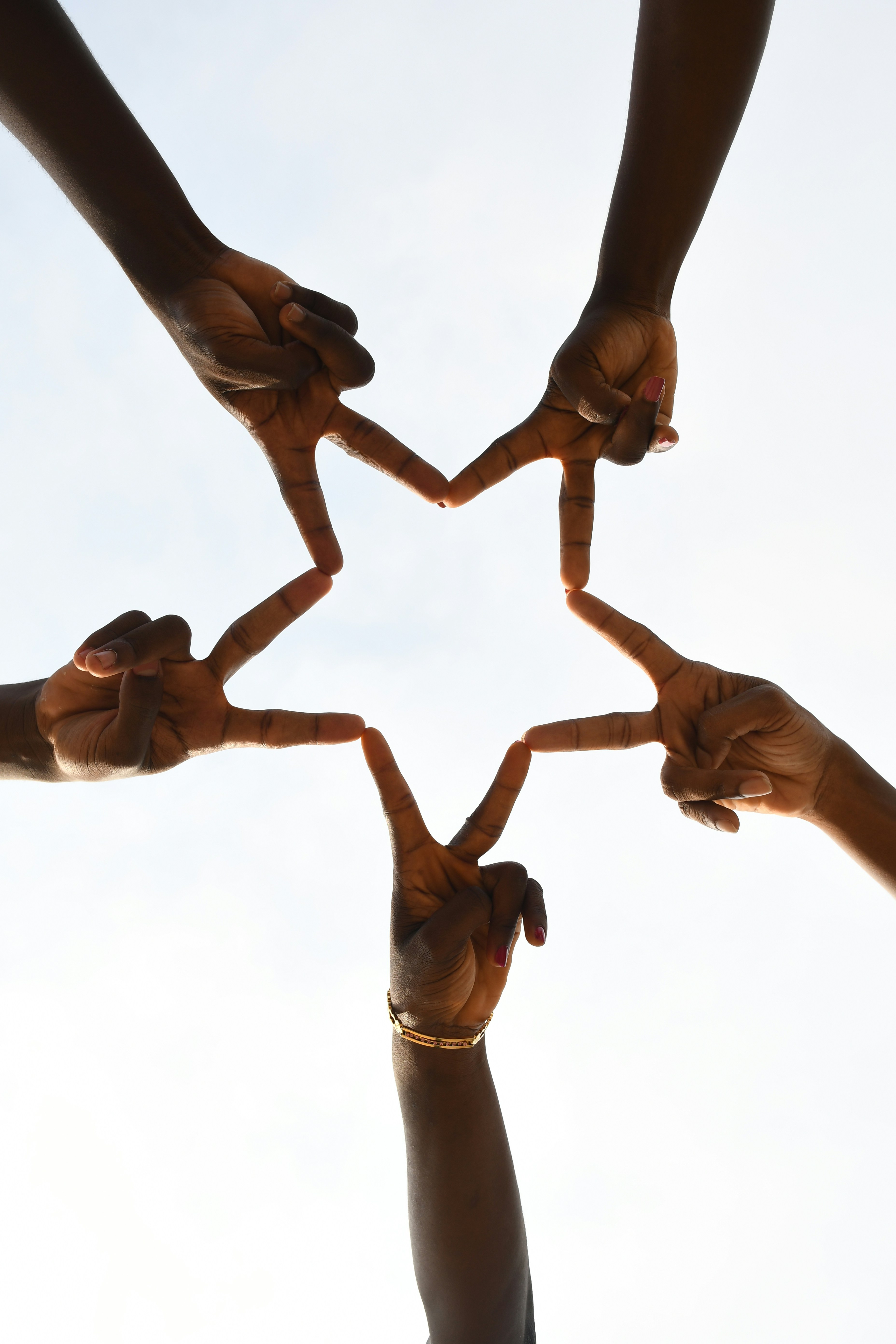 African hands forming a star — community and collaboration